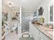 Bathroom featuring a glass walk-in shower, toilet, vanity with granite counter and a coastal theme at 17380 Se 111Th Ct, Summerfield, FL 34491