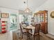 Dining room with views to the lanai, elegant table setting, and classic hutch, perfect for Gathering gatherings at 17380 Se 111Th Ct, Summerfield, FL 34491