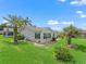 Home exterior showcasing the well-manicured lawn, landscaping, and lanai at 17380 Se 111Th Ct, Summerfield, FL 34491