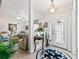 Bright foyer featuring a decorative glass door, stylish lighting, tiled floor, and a view into the living room at 17380 Se 111Th Ct, Summerfield, FL 34491