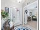 Welcoming foyer with a decorative glass front door and an inviting view into the living area at 17380 Se 111Th Ct, Summerfield, FL 34491