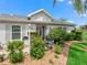 Charming single-story home with well-manicured landscaping, mature bushes, and inviting curb appeal at 17380 Se 111Th Ct, Summerfield, FL 34491