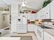 Bright kitchen with white cabinets, modern appliances, and breakfast bar, perfect for casual dining at 17380 Se 111Th Ct, Summerfield, FL 34491