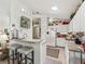 Bright, well-equipped kitchen with white cabinetry, breakfast bar, and modern appliances at 17380 Se 111Th Ct, Summerfield, FL 34491