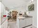 Kitchen with modern appliances, a breakfast bar, and an adjacent dining area with a vintage display cabinet at 17380 Se 111Th Ct, Summerfield, FL 34491