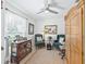 Cozy living room featuring a ceiling fan, comfortable seating, and an elegant wooden armoire at 17380 Se 111Th Ct, Summerfield, FL 34491
