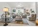 Bright living room featuring comfortable seating, neutral colors, large window, and bright natural light at 17380 Se 111Th Ct, Summerfield, FL 34491