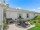 Back patio with seating area, lush greenery, and peaceful outdoor space at 17380 Se 111Th Ct, Summerfield, FL 34491