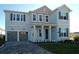 Charming two-story home featuring a two-car garage, a beautifully landscaped yard, and classic shutters at 1845 Sunshine Peak Dr, Minneola, FL 34715