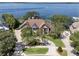 An aerial view shows the home's location with waterfront access and a long, private driveway at 1956 Brantley Cir, Clermont, FL 34711
