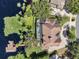 Top-down aerial view of an estate with a pool, screened lanai, private dock, and lakeside charm at 1956 Brantley Cir, Clermont, FL 34711