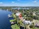 Aerial shot displaying a lakeside home with a dock and pool, nestled among lush greenery and beautiful waterfront at 1956 Brantley Cir, Clermont, FL 34711