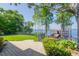 Beautiful backyard with lush landscaping, a patio, and a view of the lake and dock at 1956 Brantley Cir, Clermont, FL 34711