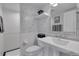 Modern bathroom featuring black-and-white tiled wallpaper, a sink, and a walk-in shower at 1956 Brantley Cir, Clermont, FL 34711