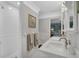 Bright bathroom boasts double sinks, a walk-in shower, and modern fixtures offering a clean and functional space at 1956 Brantley Cir, Clermont, FL 34711