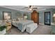Charming bedroom with a large bed, ceiling fan, and access to the outside with abundant natural light at 1956 Brantley Cir, Clermont, FL 34711