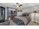 Comfortable bedroom featuring stylish decor, a ceiling fan, and natural light creating a serene and inviting space at 1956 Brantley Cir, Clermont, FL 34711