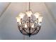 Close-up of an ornate chandelier with decorative metalwork and warm lighting at 1956 Brantley Cir, Clermont, FL 34711