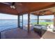 Dock with screened-in porch and outdoor seating, providing beautiful water views at 1956 Brantley Cir, Clermont, FL 34711