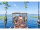 Picturesque wooden dock with a covered boathouse extending into the lake at 1956 Brantley Cir, Clermont, FL 34711