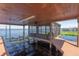 View of the boat dock on the water, featuring a screened-in enclosure at 1956 Brantley Cir, Clermont, FL 34711