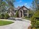 Charming two-story brick home with lush greenery and a serene front yard under a bright sky at 1956 Brantley Cir, Clermont, FL 34711