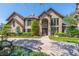 Stunning brick home featuring a well manicured lawn and beautiful landscaping at 1956 Brantley Cir, Clermont, FL 34711