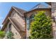Exterior detail showcasing the brickwork, turret, and unique architectural details of the home at 1956 Brantley Cir, Clermont, FL 34711