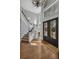 Grand foyer with hardwood floors, staircase, chandelier, and decorative glass panels at 1956 Brantley Cir, Clermont, FL 34711