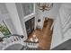Elegant foyer with hardwood floors, a grand staircase, and a statement chandelier creating a welcoming entrance at 1956 Brantley Cir, Clermont, FL 34711