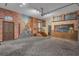 Spacious garage features unique mural artwork and a painted brick theme with ample room for vehicles and storage at 1956 Brantley Cir, Clermont, FL 34711