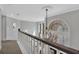 Elegant hallway featuring a decorative chandelier and a large window providing ample natural light at 1956 Brantley Cir, Clermont, FL 34711