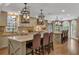 Bright kitchen featuring an island with bar stool seating and pendant lighting at 1956 Brantley Cir, Clermont, FL 34711
