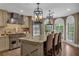 Spacious kitchen featuring a large island with a marble countertop and stainless steel appliances at 1956 Brantley Cir, Clermont, FL 34711