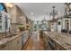 A spacious kitchen features stainless steel appliances and multiple islands with granite countertops at 1956 Brantley Cir, Clermont, FL 34711