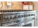 Close-up of a high-end stainless steel gas range in a modern kitchen at 1956 Brantley Cir, Clermont, FL 34711