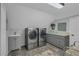 Well-equipped laundry room with modern appliances, ample counter space, and storage cabinets for convenience at 1956 Brantley Cir, Clermont, FL 34711