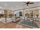 Bright living room with hardwood floors, a ceiling fan, and staircase to a kitchen at 1956 Brantley Cir, Clermont, FL 34711