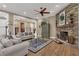 Open-concept living room features a decorative fireplace, hardwood floors, and a comfortable sofa at 1956 Brantley Cir, Clermont, FL 34711