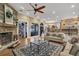 Spacious living room with hardwood floors, stone fireplace, and large windows at 1956 Brantley Cir, Clermont, FL 34711