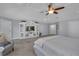 Main bedroom featuring a decorative entertainment center, accent chair, and neutral color scheme at 1956 Brantley Cir, Clermont, FL 34711