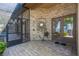 Spacious outdoor patio featuring brick flooring, screened enclosure and garden hose reel, perfect for outdoor living at 1956 Brantley Cir, Clermont, FL 34711