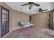 Cozy patio with a charming porch swing, ceiling fans, and stylish decor, perfect for outdoor enjoyment at 1956 Brantley Cir, Clermont, FL 34711