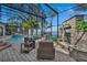 Beautiful screened pool area with comfortable outdoor seating and peaceful water views at 1956 Brantley Cir, Clermont, FL 34711