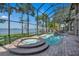Inviting screened pool and hot tub area with gorgeous waterfront views at 1956 Brantley Cir, Clermont, FL 34711
