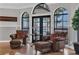 Cozy seating area with lake views through arched windows and access to a patio at 1956 Brantley Cir, Clermont, FL 34711
