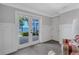 Seating room that looks out onto the water through the glass sliding doors at 1956 Brantley Cir, Clermont, FL 34711