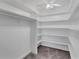 Large, empty walk-in closet with shelving and carpeted floors at 1956 Brantley Cir, Clermont, FL 34711