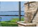An eye-level shot of a brick water feature with a lake in the background at 1956 Brantley Cir, Clermont, FL 34711