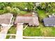 Aerial view showcases the home, green lawn, fenced backyard, and mature trees surrounding the property at 2007 Mosher Dr, Orlando, FL 32810